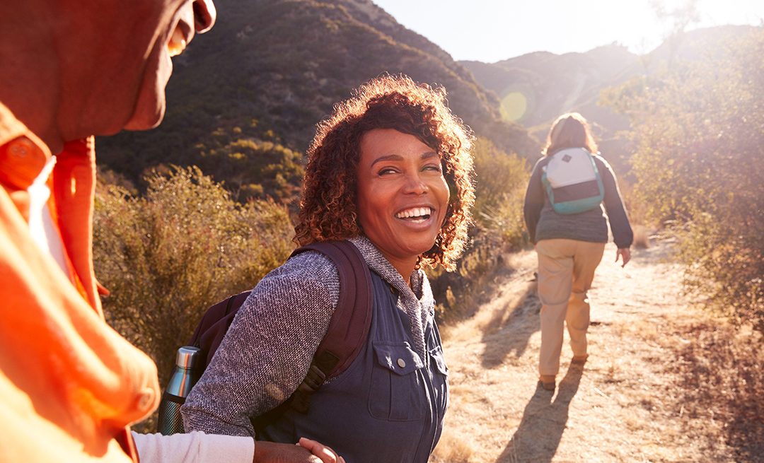Healthy active adults hiking outdoors supporting immune health after 40