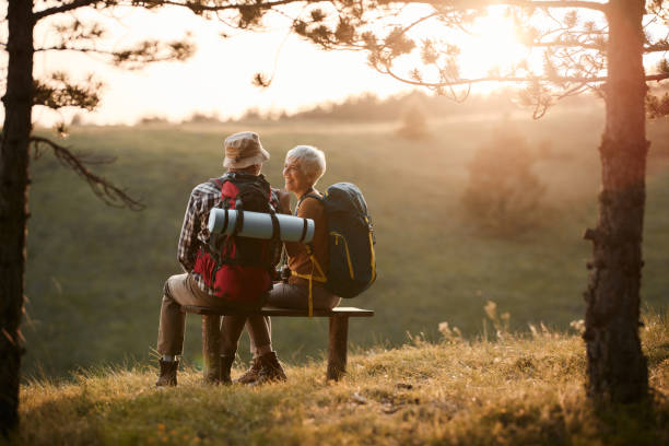 Active older couple hiking outdoors at sunrise supporting healthy aging and homeostasis